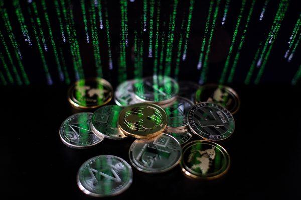 A photo illustration of Ripple, Litecoin, and Ether digital tokens is seen in London, on April 25, 2018. (Jack Taylor/Getty Images)