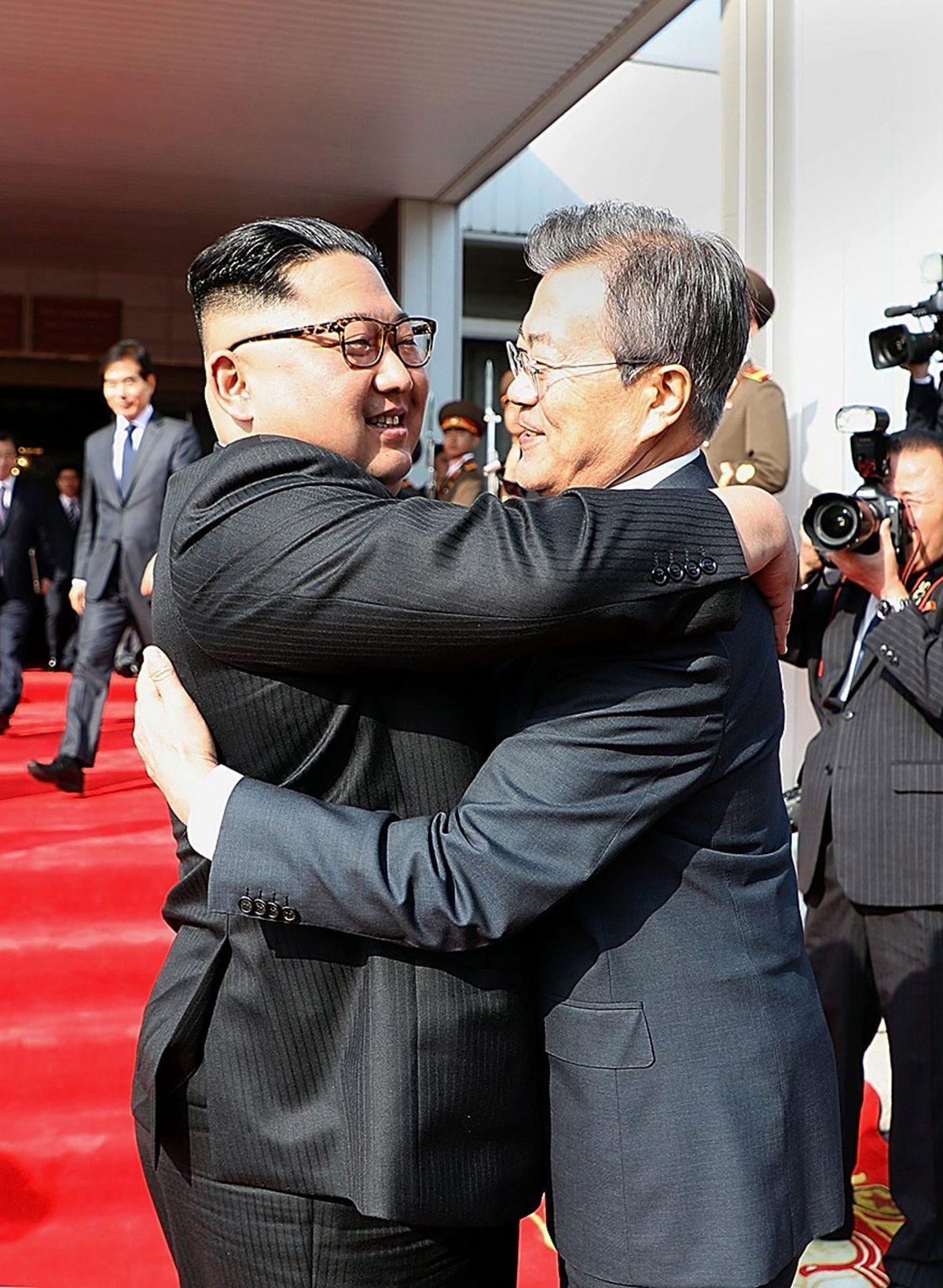 South Korean President Moon Jae-in (R) hugs North Korean leader Kim Jong-un (L) before their meeting in Panmunjom, North Korea, on May 26, 2018. (South Korean Presidential Blue House via Getty Images)