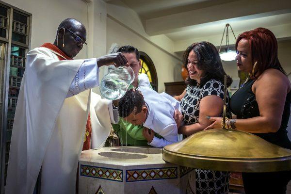 A baptism that Koek happened upon while he was waiting in Saint Angela Merici Church on Morris Avenue, in the Bronx. (Courtesy of Richard Koek)