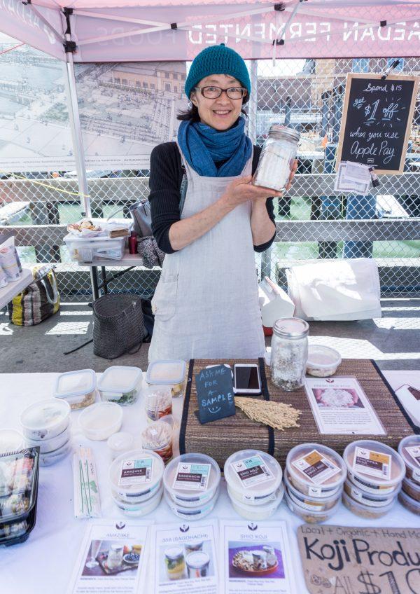 Mariko Grady of Aedan Fermented Foods, holding a jar of handmade koji. (Crystal Shi/The Epoch Times)