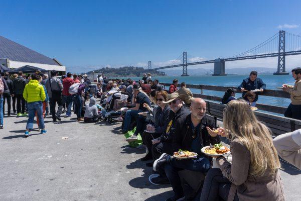 Market-goers can stroll along the pier, or fill their plates and grab a seat to enjoy a waterfront meal with views of the Bay Bridge. (Crystal Shi/The Epoch Times)