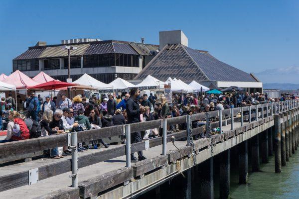 Crowds and a sea of tents along the pier. (Crystal Shi/The Epoch Times)