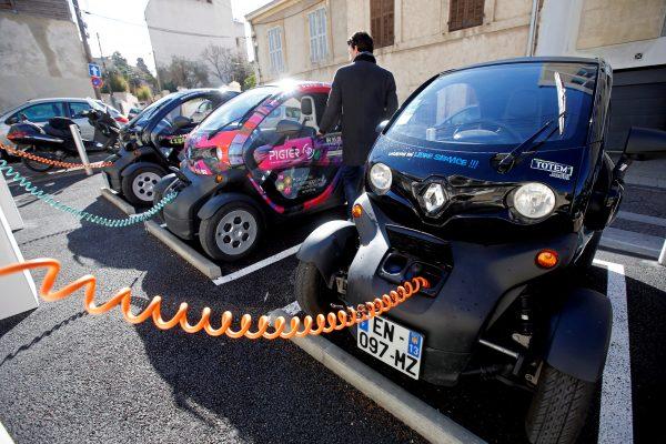 A man prepares to drive a Totem-Mobi electric car-sharing vehicle parked at a charging station in Marseille, France, on March 6, 2018. (Reuters/Jean-Paul Pelissie//File Photo)