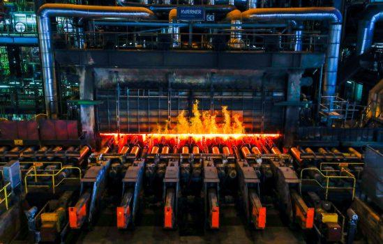 A red-hot steel plate passes through a press at the ArcelorMittal steel plant in Ghent, Belgium, May 22, 2018. (Reuters/Yves Herman/File Photo)