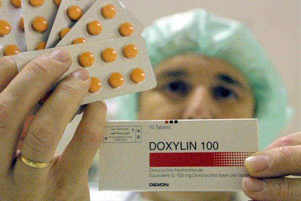 A worker at the Dexxon pharmaceutical plant holds up a package of their Doxylin antibiotics drug in the Israeli town of Or Akiva on Nov. 8, 2001. Doxylin is the trade name for Doxycycline Hydrochloride, one of the three antibiotics effective in combating anthrax infections. (David Silverman/Getty Images)