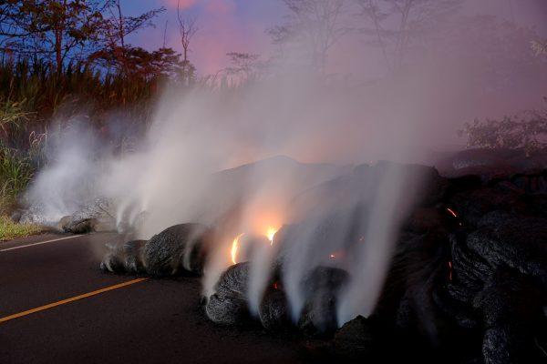 Volcanic gases rise from the Kilauea lava flow that crossed Pohoiki Road near Highway 132, near Pahoa, Hawaii, May 28. (Reuters/Marco Garcia)
