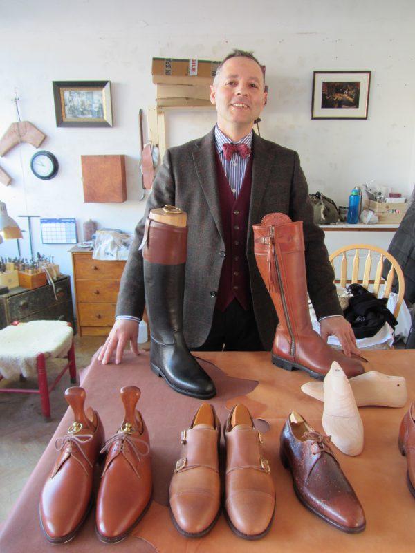 Bespoke bootmaker Mariano Palencia Crespo in his workshop with a selection of his handcrafted boots and shoes made from vegetable-tanned leather from European hides. (Courtesy of Mariano Palencia Crespo)