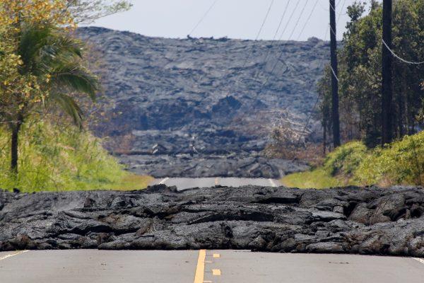 Lava covers a road in Pahoa during ongoing eruptions of the Kilauea Volcano in Hawaii, U.S., June 3, 2018. (Reuters/Terray Sylvester)