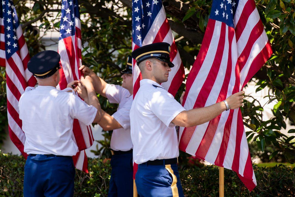 Service members prepare the American flags for the Celebration of America on the South Lawn of the White House in Washington on June 5, 2018. (Samira Bouaou/The Epoch Times)