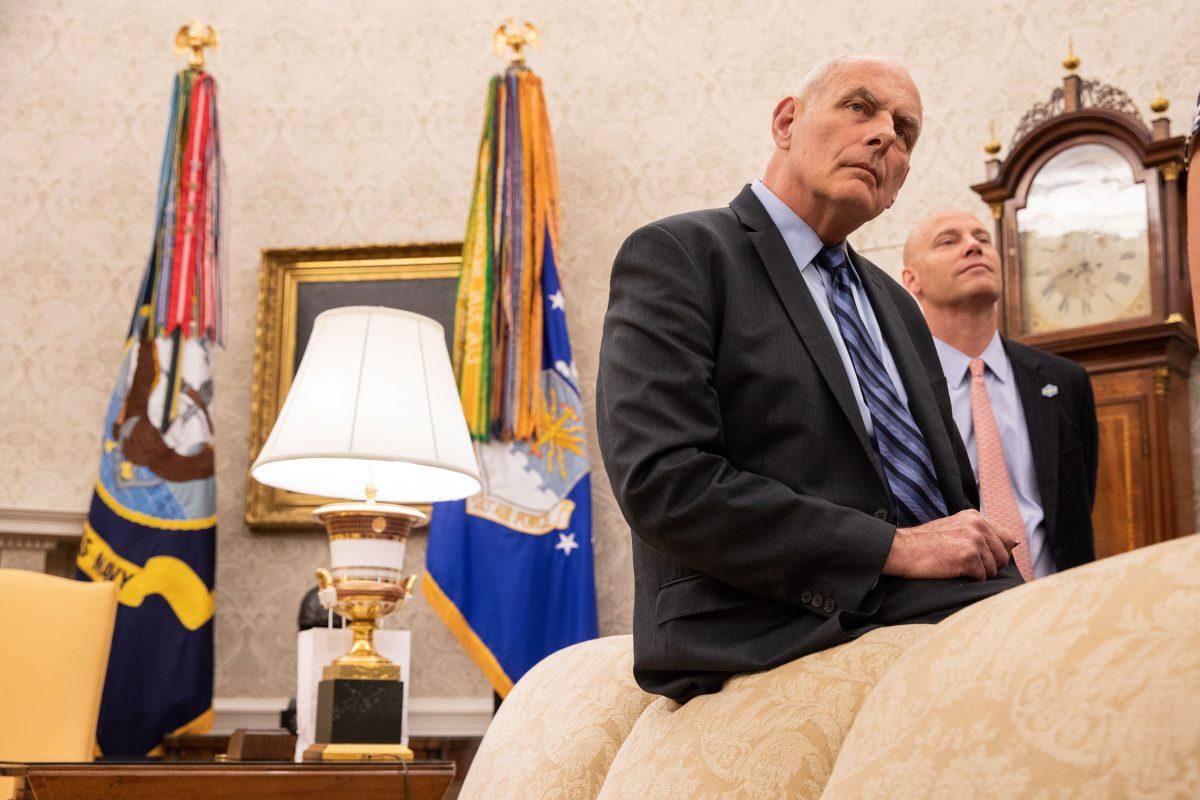 White House Chief of Staff John Kelly sits as President Donald Trump participates in the signing ceremony for S. 292 – The Childhood Cancer Survivorship, Treatment, Access, and Research Act of 2018 in the Oval Office at the White House in Washington on June 5, 2018. (Samira Bouaou/The Epoch Times)