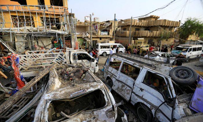 Wreckages of destroyed vehicles are seen at the site of an explosion in Baghdad's Sadr City district, Iraq June 7, 2018. (Thaier Al-Sudani/Reuters)