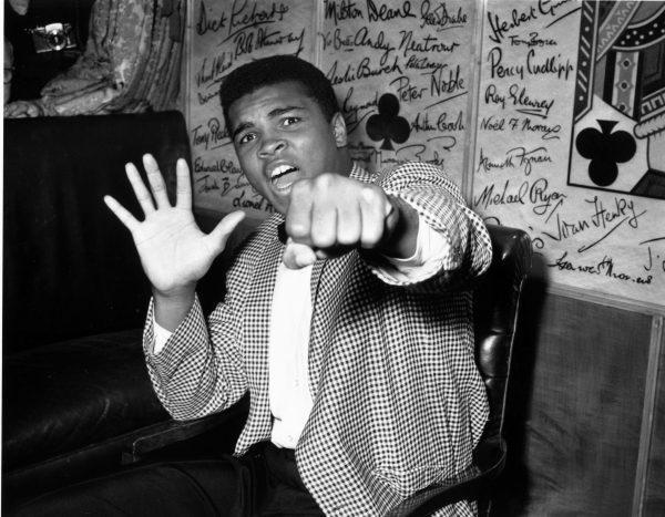 Cassius Clay, before changing his name to Muhammad Ali, on May 27, 1963, holds up five fingers in a prediction of how many rounds it will take him to knock out British boxer Henry Cooper. (Kent Gavin/Keystone/Getty Images)