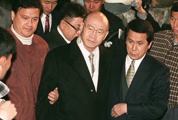 Former South Korean President Chun Doo-Hwan (C) is arrested by prosecution authorities at a relative's house in Hapchon, Korea, some 200 miles south of Seoul on Dec. 3, 1995. Chun was then taken to Seoul's Anyang prison to be held on charges of leading a 1979 military coup. (KIM JAE-HWAN/AFP/Getty Images)