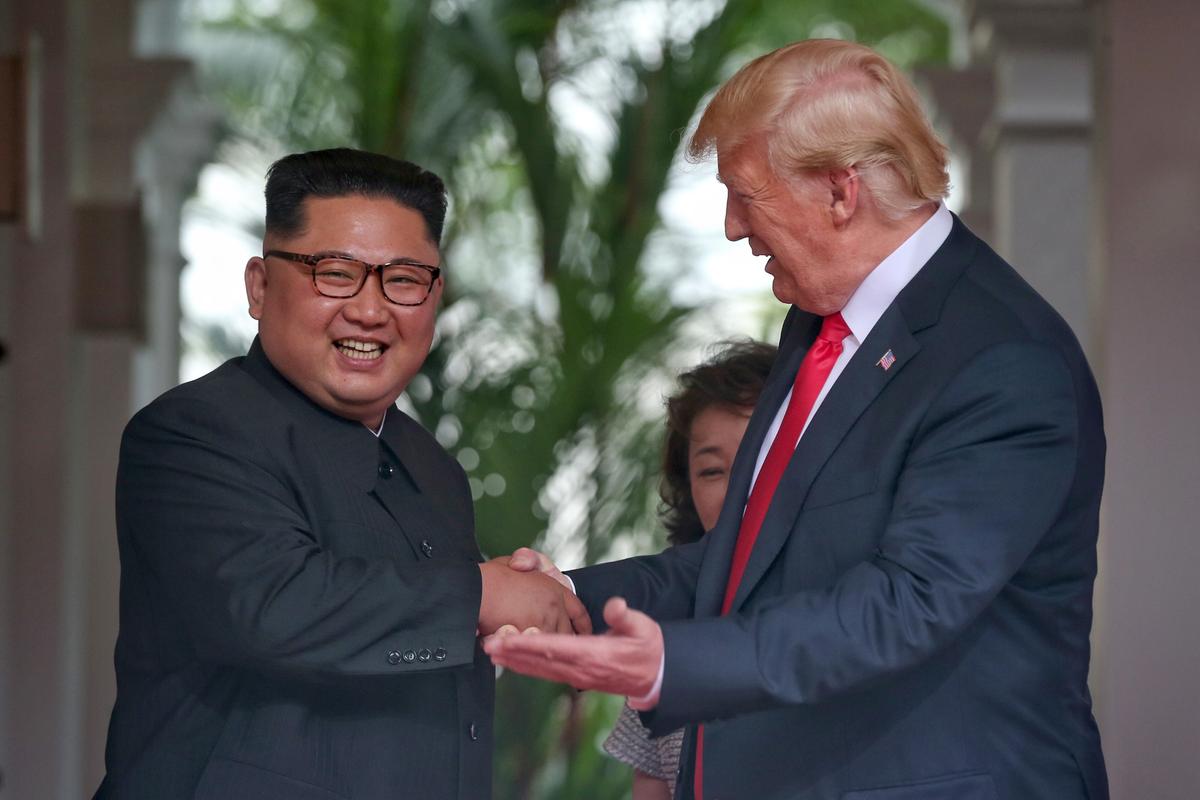North Korean leader Kim Jong-un shakes hands with U.S. President Donald Trump during their historic U.S.-DPRK summit at the Capella Hotel on Sentosa island on June 12, 2018 in Singapore. (Kevin Lim/THE STRAITS TIMES/Handout/Getty Images)