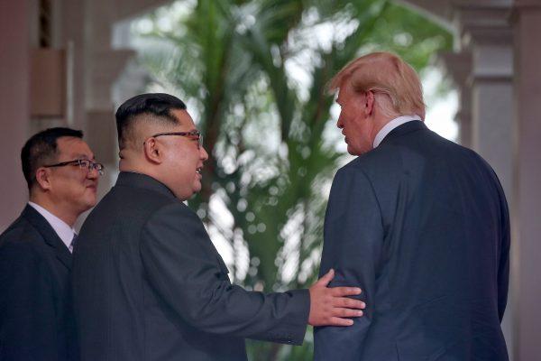 North Korean leader Kim Jong Un meets President Donald Trump during their historic U.S.-DPRK summit at the Capella Hotel on Sentosa Island in Singapore on June 12, 2018. (Kevin Lim/THE STRAITS TIMES/Handout/Getty Images)
