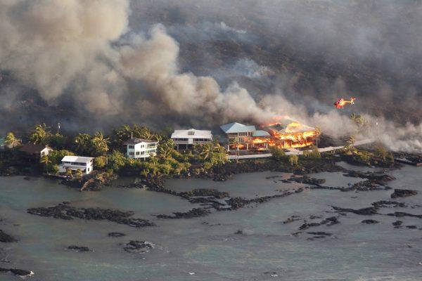 Lava destroys homes in the Kapoho area, east of Pahoa, during ongoing eruptions of the Kilauea Volcano in Hawaii, U.S., June 5, 2018. (Reuters/Terray Sylvester)