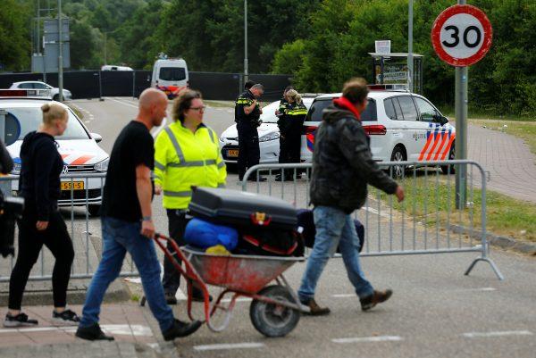 Visitiors leave the festival grounds as police are seen near a scene where a van struck into people after a concert in Landgraaf, the Netherlands June 18, 2018. (Reuters/Thilo Schmuelgen)