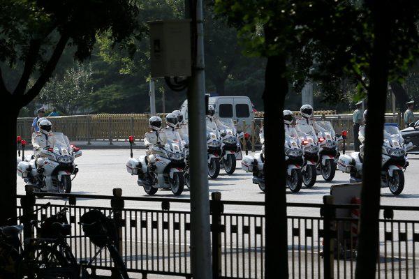 Police motorcycles accompany a motorcade believed to be carrying North Korean leader Kim Jong Un in Beijing, China, on June 19, 2018. (Thomas Peter/Reuters)