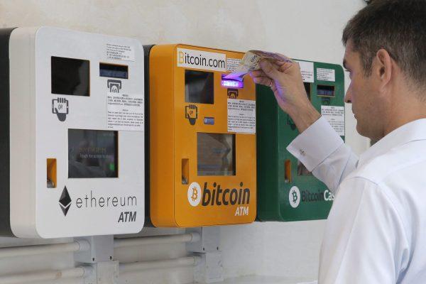 A man uses a Bitcoin ATM in Hong Kong on May 11, 2018. (Kin Cheung/AP Photo)