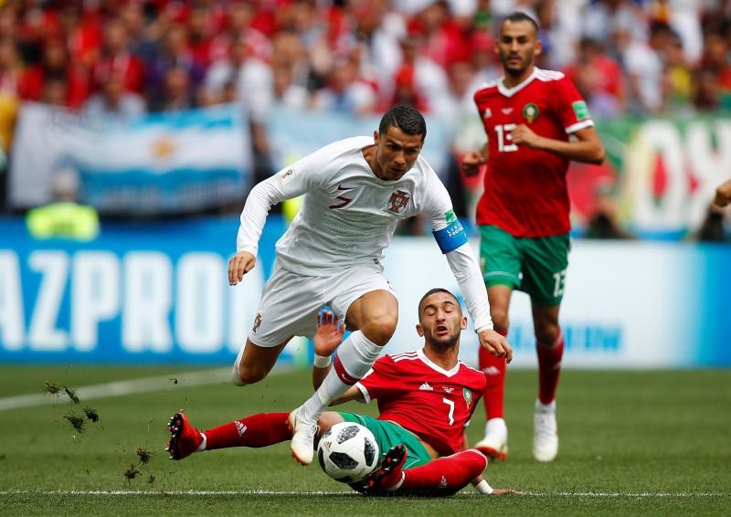 Soccer Football - World Cup - Group B - Portugal vs Morocco - Luzhniki Stadium, Moscow, Russia - June 20, 2018 Portugal's Cristiano Ronaldo in action with Morocco's Hakim Ziyech. (REUTERS/Axel Schmidt)