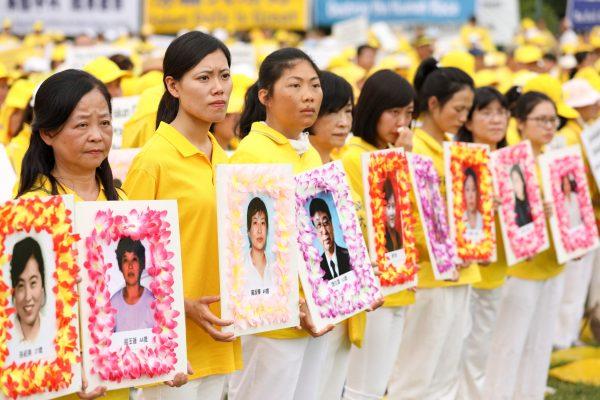 Falun Gong practitioners commemorate the deaths adherents who were persecuted to death by the Chinese regime, during a march down Pennsylvania Ave. in Washington, D.C. on June 20, 2018. (Samira Bouaou/The Epoch Times)