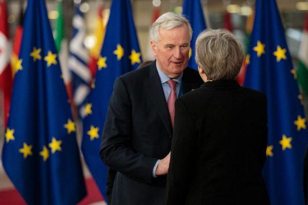 Chief negotiator for the European Union Michel Barnier (C) greets British Prime Minister Theresa May at the Council of the European Union on March 23, 2018, in Brussels, Belgium. (Jack Taylor/Getty Images)