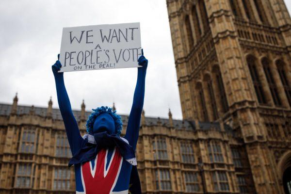 An anti-Brexit campaigner holds up a placard outside the Houses of Parliament in London on April 16, 2018. (Photo by Jack Taylor/Getty Images)