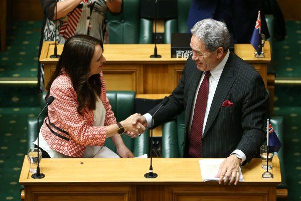 Prime Minister Jacinda Ardern shakes hands with Deputy Prime Minister Winston Peters after her speech during the 2018 budget presentation at Parliament on May 17, 2018 in Wellington, New Zealand. (Hagen Hopkins/Getty Images)