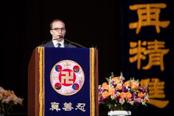 Ben Maloney talks about his experience of practicing the spiritual discipline Falun Gong, at the Capital One Arena in Washington on June 21, 2018. (Edward Dye/The Epoch Times)