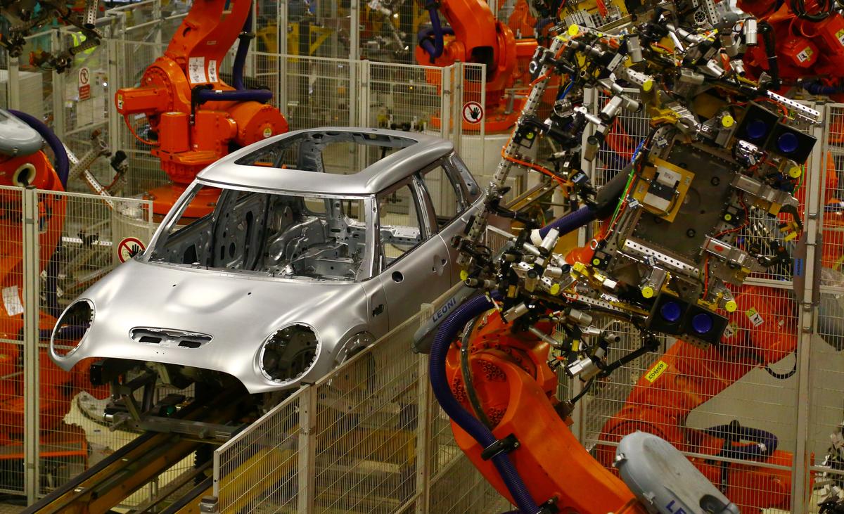 Minis in the 'Body in white' stage of manufacture pass along a robotic assembly line at the BMW Mini car production plant in Oxford, west of London, on January 17, 2017. (GEOFF CADDICK/AFP/Getty Images)