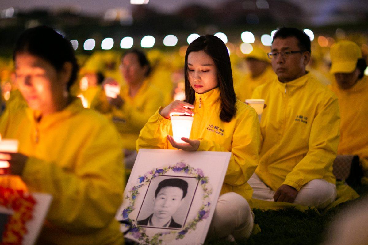 Falun Gong practitioners take part in a candlelight vigil to commemorate the practitioners killed in China for their belief, in Washington on June 22, 2018. (Benjamin Chasteen/The Epoch Times)