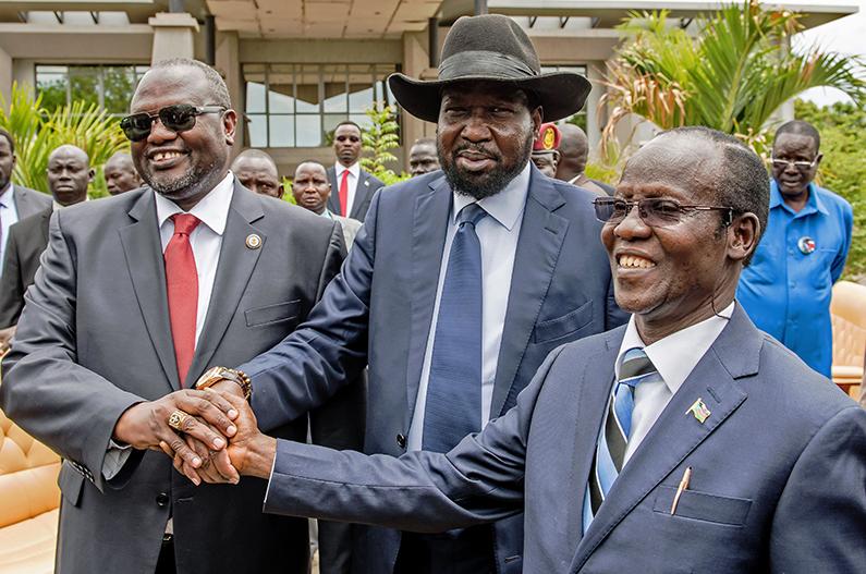 The Deal That Didn’t Last: (L-R) First Vice President of South Sudan and former rebel leader Riek Machar, South Sudan President Salva Kiir and Second Vice President of South Sudan James Wani Igga shake hands after the formation of the new cabinet of the Transitional Government at the Cabinet Affairs Ministry in Juba on April 29, 2016. (Charles Lomodong/AFP/Getty Images)