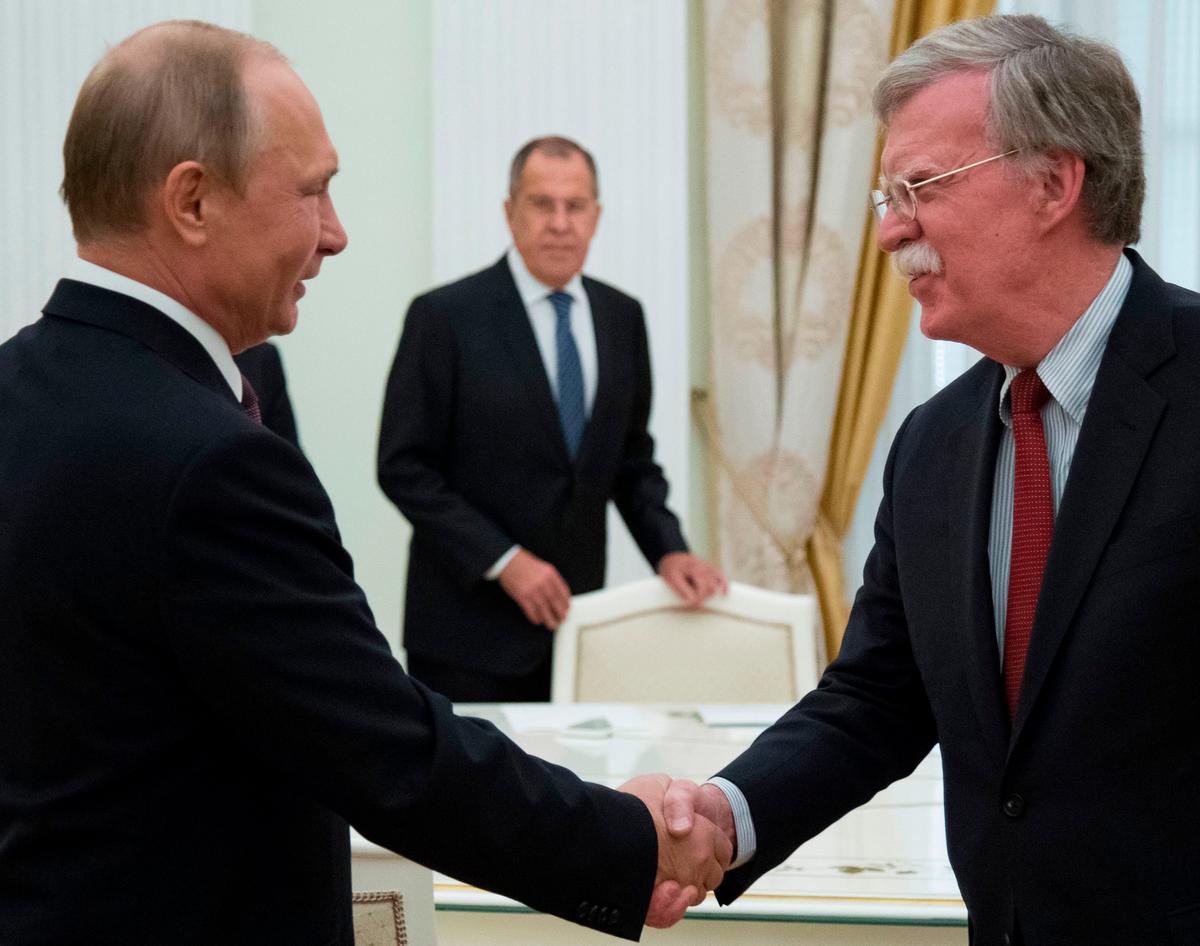 Russian President Vladimir Putin (L) shakes hands with U.S. National security adviser John Bolton as Russian Foreign Minister Sergei Lavrov (C) looks on during the meeting in the Kremlin in Moscow, Russia, on June 27, 2018. (Alexander Zemlianichenko/AFP/Getty Images)