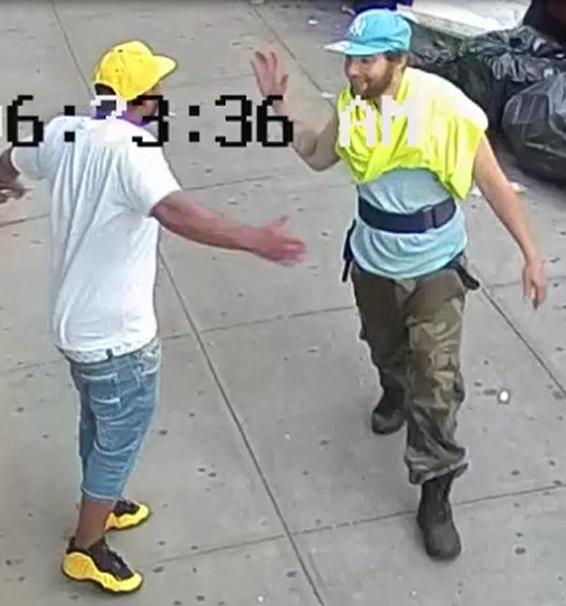 Two men caught on camera high-fiving after one of them knocked a man unconscious in a Bronx street on June 18, 2018. (NYPD)