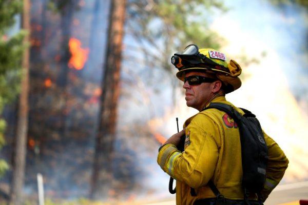 Todd Abercrombie, of Cal Fire watches the fire behavior as firefighters monitor fire movement as it crosses Highway 299 just west of Buckhorn Summit near the Trinity County line. (Kelly Jordan via USA Today Network)