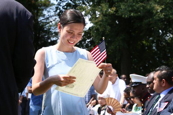 Thao Tran from Vietnam obtains her naturalization certificate during an event at President George Washington's historic home in Mount Vernon, Va., on July 4, 2018. (Samira Bouaou/The Epoch Times)
