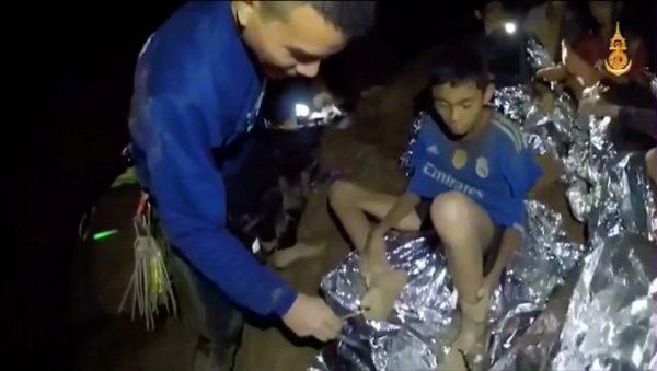 Boys from the soccer team trapped inside Tham Luang cave receive treatment from a medic in Chiang Rai, Thailand, on July 3, 2018. (Thai Navy Seal/Handout via ReutersTV)