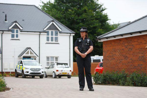 A police officer stands in front of a housing development on Muggleton Road, which has been cordoned off after two people were hospitalized and police declared a 'major incident', in Amesbury, Wiltshire, United Kingdom, July 4, 2018. (Reuters/Henry Nicholls)