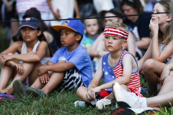 Children watch the Independence Day events at President George Washington's historic home in Mount Vernon, Va., on July 4, 2018. (Samira Bouaou/The Epoch Times)