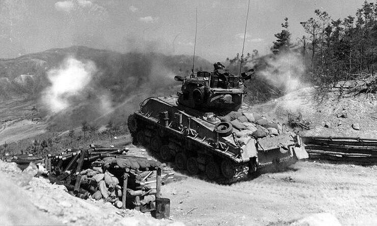 A column of troops and armor of the 1st Marine Division move through communist Chinese lines during their successful breakout from the Chosin Reservoir in North Korea during the Korean War. (Cpl. Peter McDonald/U.S. Marine Corps)