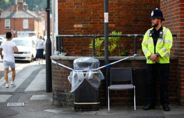 A police officer guards a cordoned off rubbish bin on Rolleston Street, after it was confirmed that two people had been poisoned with the nerve-agent Novichok, in Salisbury, Britain, July 5, 2018. (Henry Nicholls/Reuters)