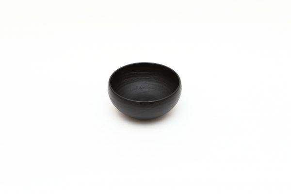 Black Japanese lacquer: urushi. Hard to work but feels soft and light. Bowl by Tokeshi. (Japan House London)