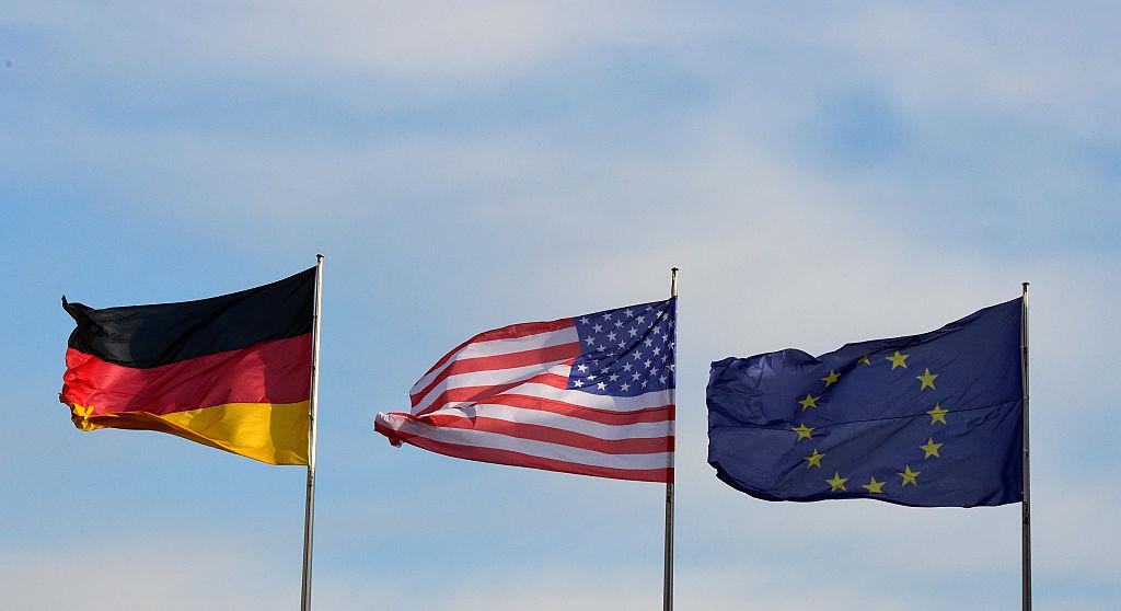 (L-R) The flags of Germany, the United States, and the European Union flutter at the Chancellery in Berlin, Germany on Nov. 17, 2016. (Tobias Schwarz/AFP/Getty Images)