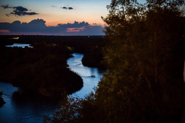 Four aliens attempt to sneak across the Rio Grande from the Mexico side to the Texas city of Roma on May 31, 2017. (Benjamin Chasteen/The Epoch Times)