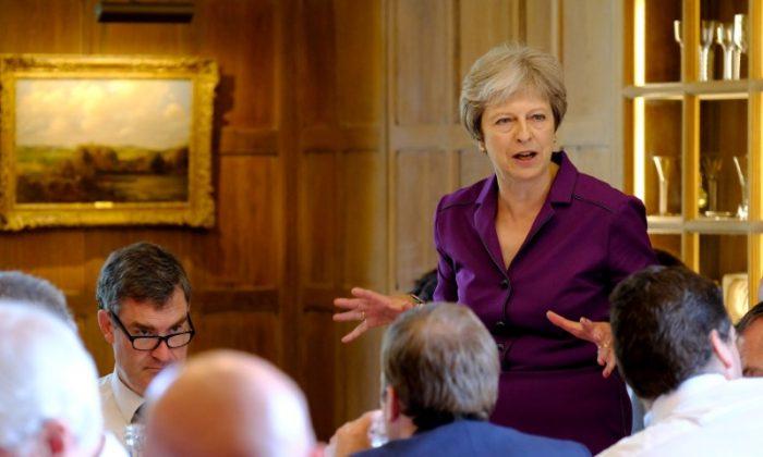 May Secures Support From UK Government on ‘Soft Brexit’ Plan
