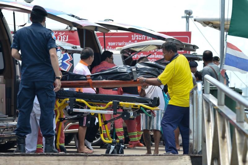Thai Rescue workers carry the body of a victim on a stretcher, after a boat capsized off the tourist island of Phuket, Thailand, July 6, 2018. (Sooppharoek Teepapan/Reuters)