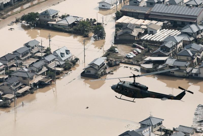 A helicopter flies over Mabi town which was flooded by the heavy rain in Kurashiki, Okayama Prefecture, Japan, in this photo taken by Kyodo July 9, 2018. (Kyodo/via Reuters)