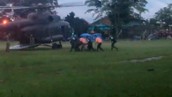 Paramedics, believed to be carrying a boy who has been evacuated after being trapped inside a flooded cave, approach a helicopter in Chiang Rai, Thailand, July 8, 2018, in this still image obtained from social media. (Chiang Rai Tourist Police/via Reuters)