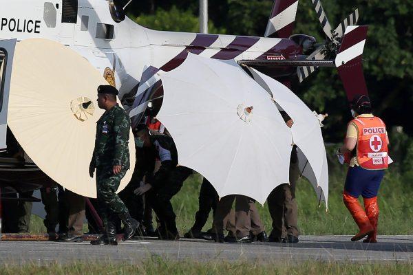 Rescued schoolboys are moved from a Royal Thai Police helicopter to an awaiting ambulance at a military airport in Chiang Rai, Thailand, July 9, 2018. (Reuters/Athit Perawongmetha)