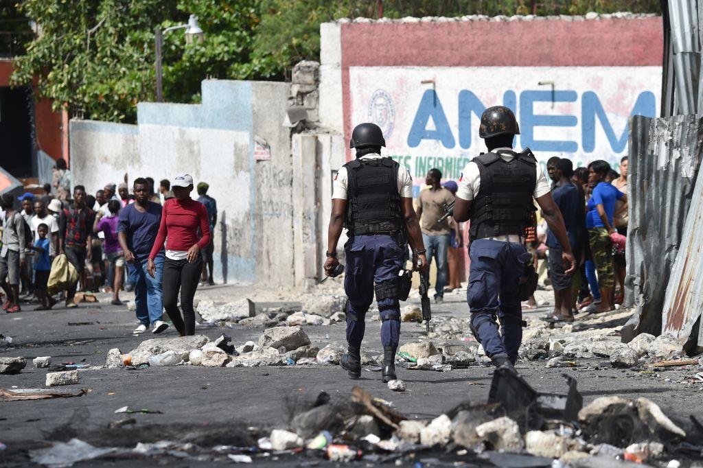 Haitian police arrive to control the situation after looting at a store in Delmas, a commune near Port-au-Prince, during protests against the rising price of fuel, on July 8, 2018. (HECTOR RETAMAL/AFP/Getty Images)